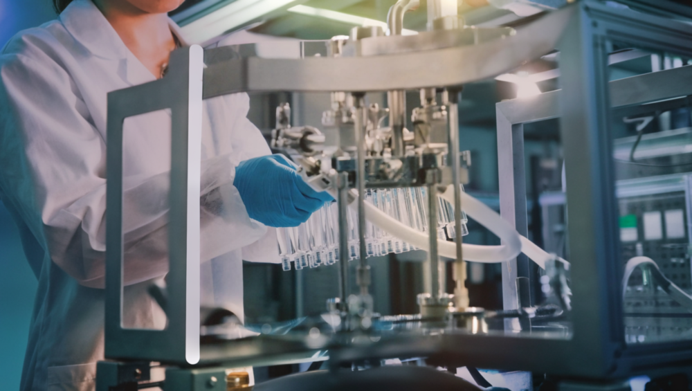 Technician operating advanced cosmetic production machinery for facial mask manufacturing.